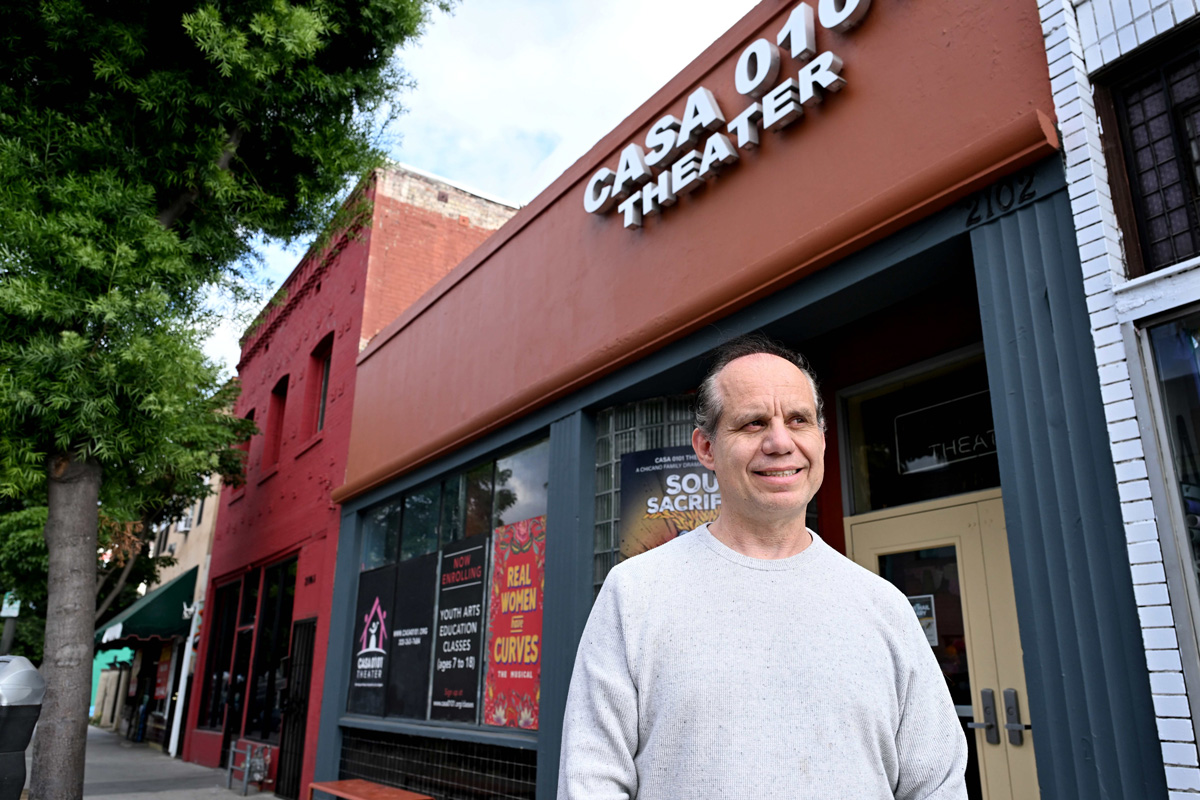 Casa0101's executive director Emmanel Deleage in front of the complex's main entrance on E. First Street in Boyle Heights. Buying the building would bring "a bedrock of stability," he says.