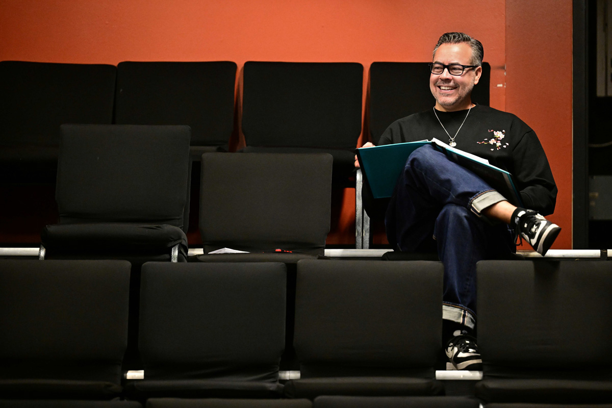 Kenneth Castillo, director of the play "Soul Sacrifice" is seated in the theater, getting ready to lead a dress rehearsal.
