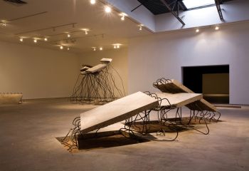 Get off me… I’m not on you! (Foreground), 2009, Pulled concrete slab, rebar, and dirt, 4 ft. x 16 ft. x 9 ft. Ruben Ochoa