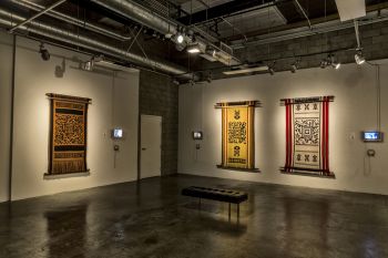 Encoded Textiles, 2013. Textile, Wool, barcode & documentary video & 5 video screens, 5 large format textiles of about 88 in. (h) x 48in. (w) Guillermo Bert