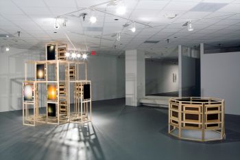 Left: The Tél, 2013, Oil on linen mounted on wood structure 10 ft. x 10 ft. x 10 ft. Right: lo-opticon (Black Hole Son), 2014, Oil on linen mounted on wood structure, 3.5 ft. x 8 ft. x 8 ft., installation view Mark Flores