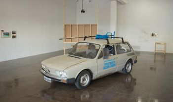 Brasília, Cars, Pools and Other Modernities (installation view Artpace San Antonio), 2009-2013, Volkswagen Brasilia, cleaning pool equipment, single-channel video, photographs, book, aluminum plaque, letter, photo transfers and drawing. Originally commissioned and produced by Artpace San Antonio. Photo by Todd Johnson. Clarissa Tossin