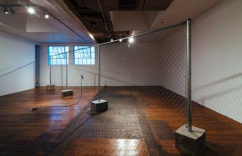 The Fence Mechanisms, 2014, Commonwealth & Council, Los Angeles, chain link fencing, concrete, beaded jump rope, durational performance, dimensions variable, Photo: Craig Kirk EJ Hill