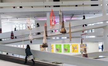 Cosmotarrafas, 2016, hand dyed fishing nets, sticks, seeds, coper plates, ceramic, oil, embroidery, iron ore, fishing rods, clothes, sandals, candles, baskets, cotton string, dimensions vary, installation view at 32 Sao Paulo Bienal. Carolina Caycedo