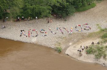 Rios Vivos; 2014; performance; Magdalena River; In Collaboration with Jaguos and Rios Vivos Collectives, the body of participants write a living message: in.Rios Vivos-Living Riversin., on the riverbank of the Magdalena River in Colombia. This gestureworks as a re-appropriation of a river landscape, which is in the process of privatization. Carolina Caycedo