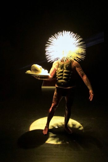 Acephalous Monster; 2018; performance, scene: “Esoterrorist”, exploding head aura; cast of artist's head on a plate. Ron Athey