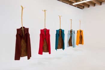 Five Sheaths; 2017; installation shot at Chimento Contemporary; Los Angeles; cotton garments each 48 in. x 18 in. x 4 in. on wood hangars 54 in. tall. Photo by Ruben Diaz Phyllis Green