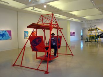 Binarynversion-Jedi; 2015; installation view; 3rd Los Angeles SUR:Biennial; Torrance Art Museum; Torrance, CA; 2 glider swing-sculptures, 8 ft. x 8 ft. x 10 ft. each, fragmented memory, fabric, acrylic on wood & steel, 6 “space explosion” paintings, acrylic on wood, 48 in. x 84 in. each Ismael de Anda III