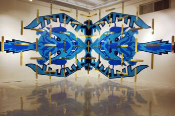 Transporter Room (Twin Paradox); 2015; Fine Arts Gallery, Cal State L.A.; Los Angeles, CA; Thunderbird / Blue Devil mutant design, latex paint on corner of gallery wall, gold & silver laser-cut acrylic mirror slivers; 384 in. x 108 in. Ismael de Anda III