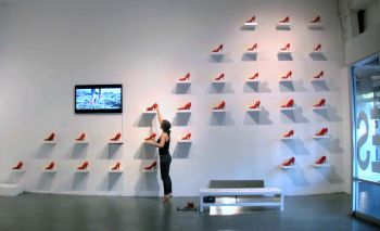Installation view of Peep Totter Fly, 2011, interactive installation at LACE, Los Angeles, CA, video, high heeled shoes, shelves, mirror, bench, dimensions vary Cheri Gaulke